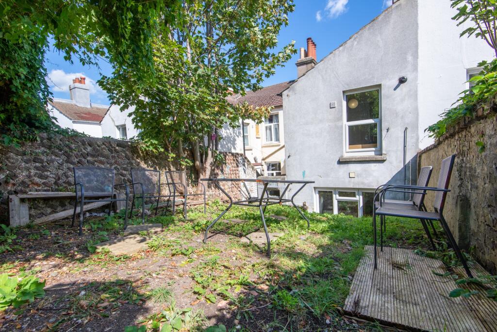 A charming outdoor garden area featuring mature...