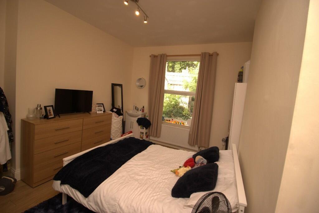 A cozy double bedroom featuring a neatly made b...