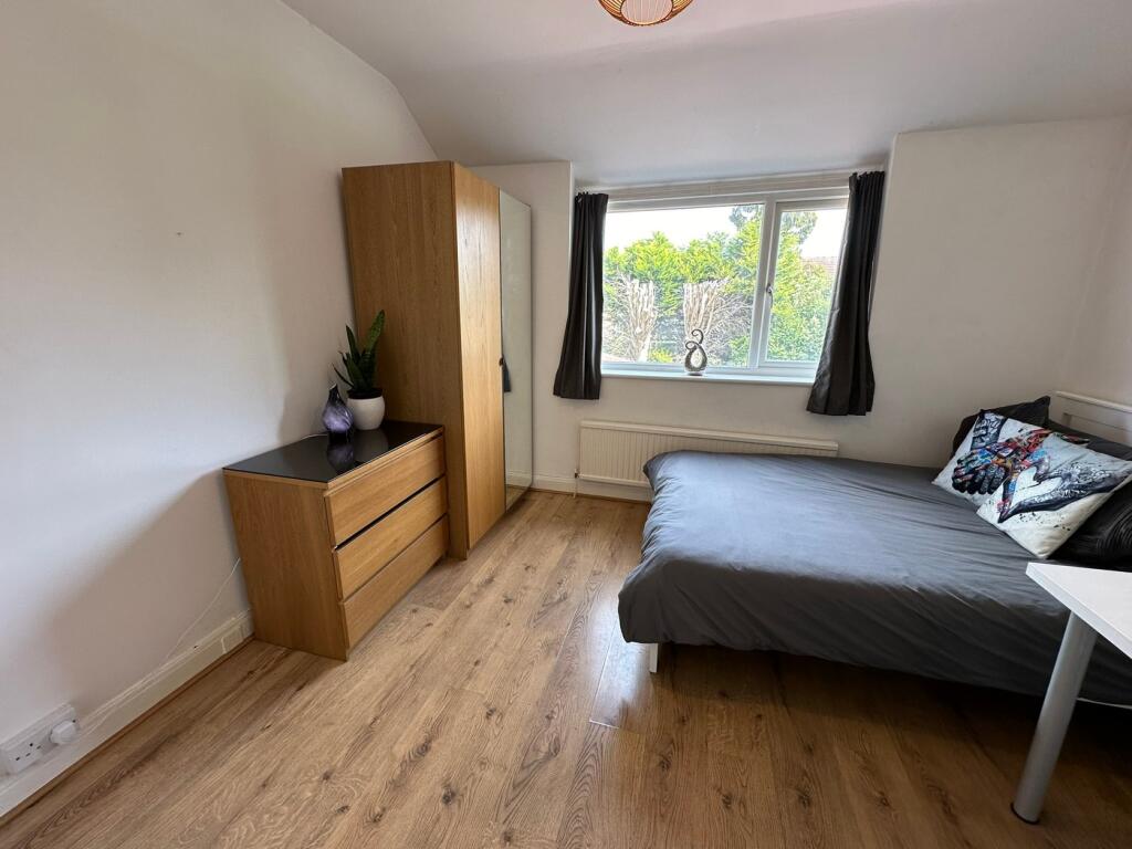 A cozy double bedroom featuring stylish wooden ...