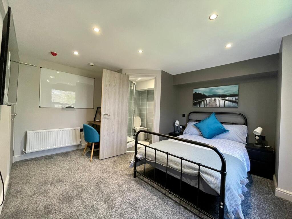 Spacious double bedroom featuring a comfortable...