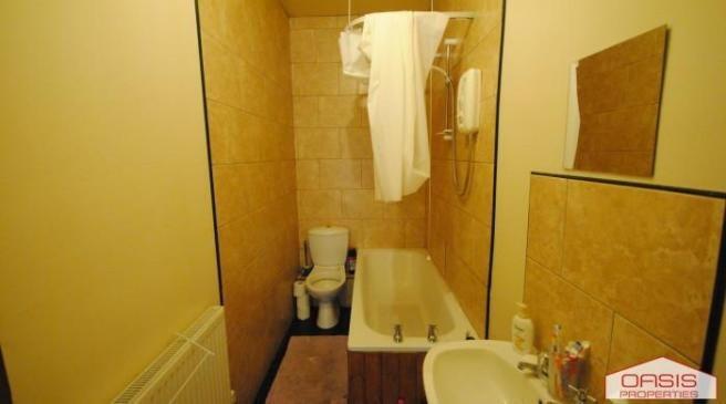 A large bathroom with a bathtub, featuring good...