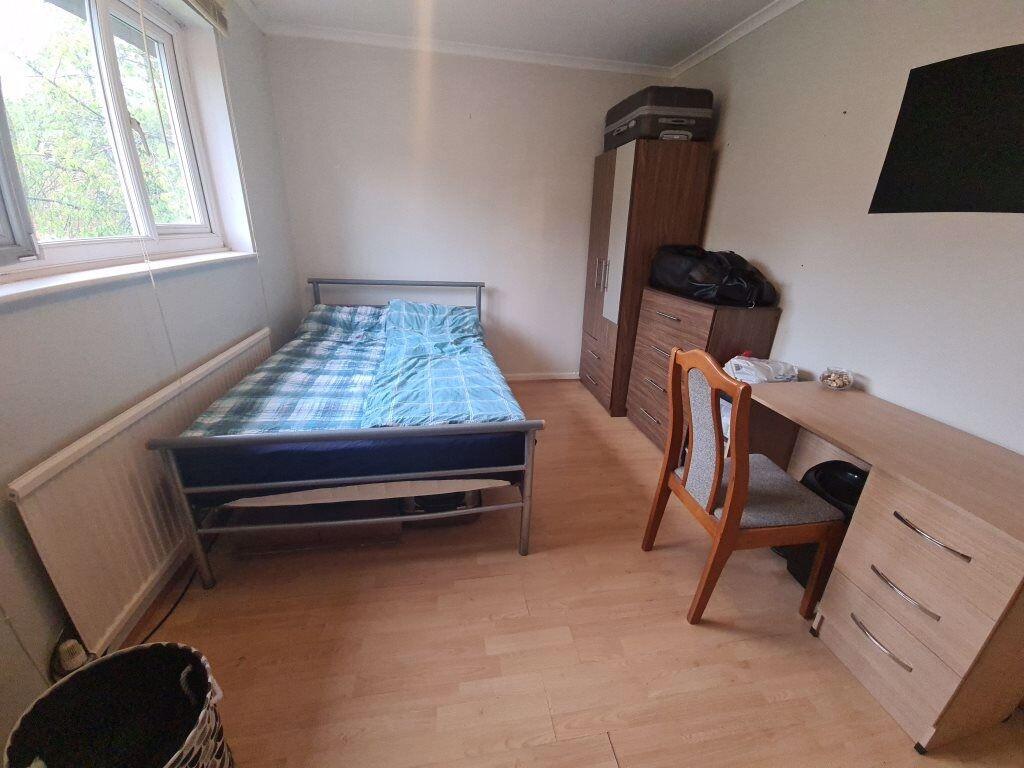 Bright, simply furnished double bedroom with a ...