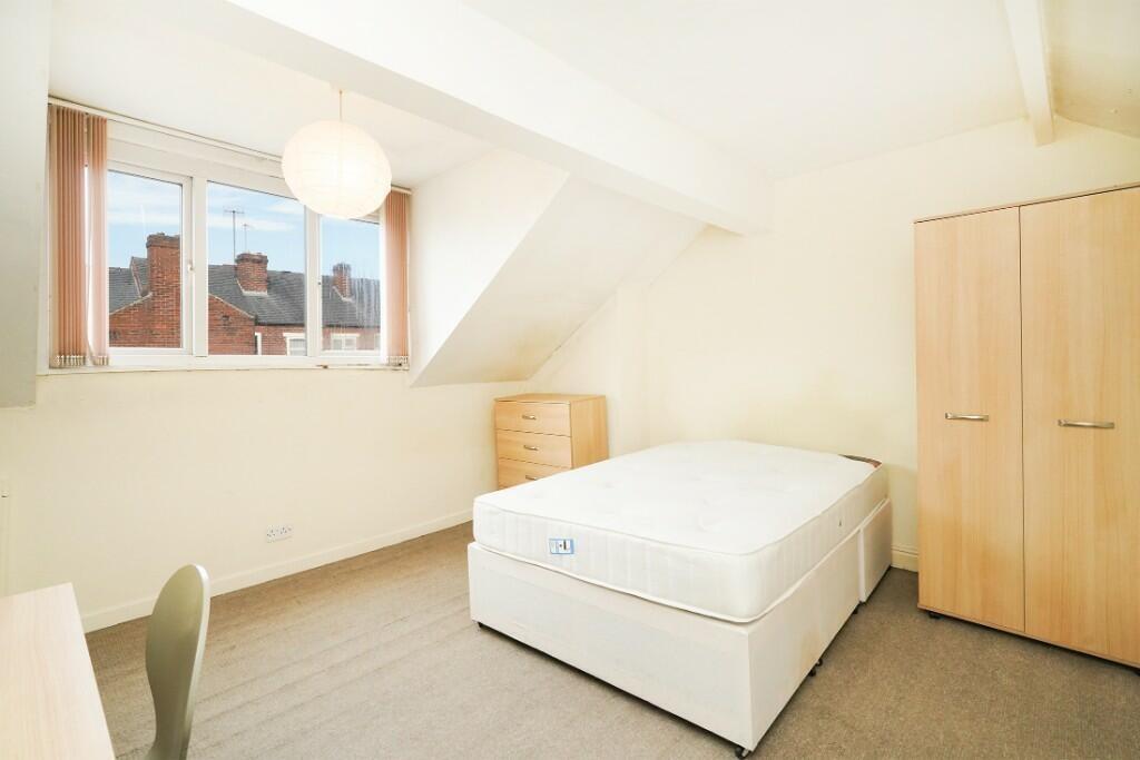 Bright and tidy double bedroom featuring a comf...