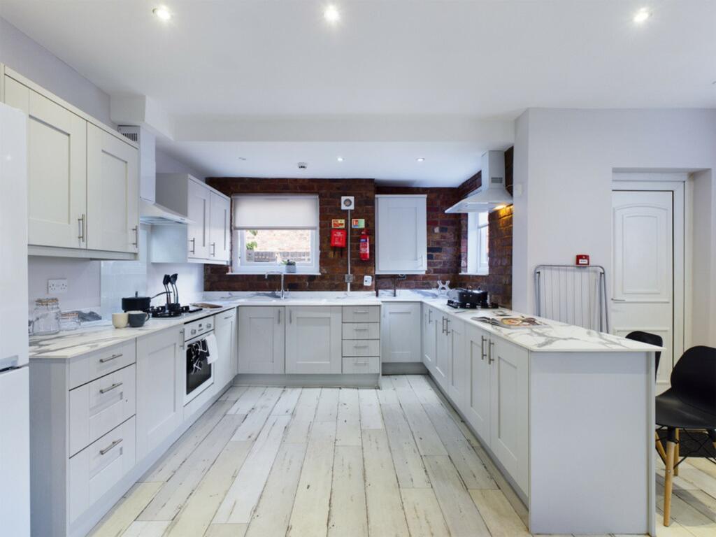 A spacious and modern kitchen with stylish fini...