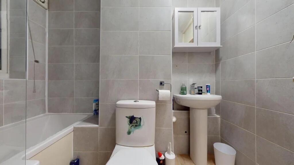A clean and modern bathroom suite featuring a b...