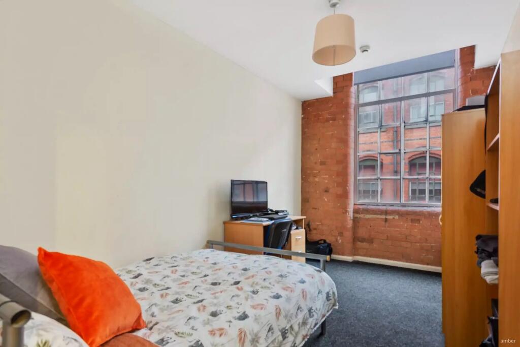 A spacious and inviting double bedroom with lar...