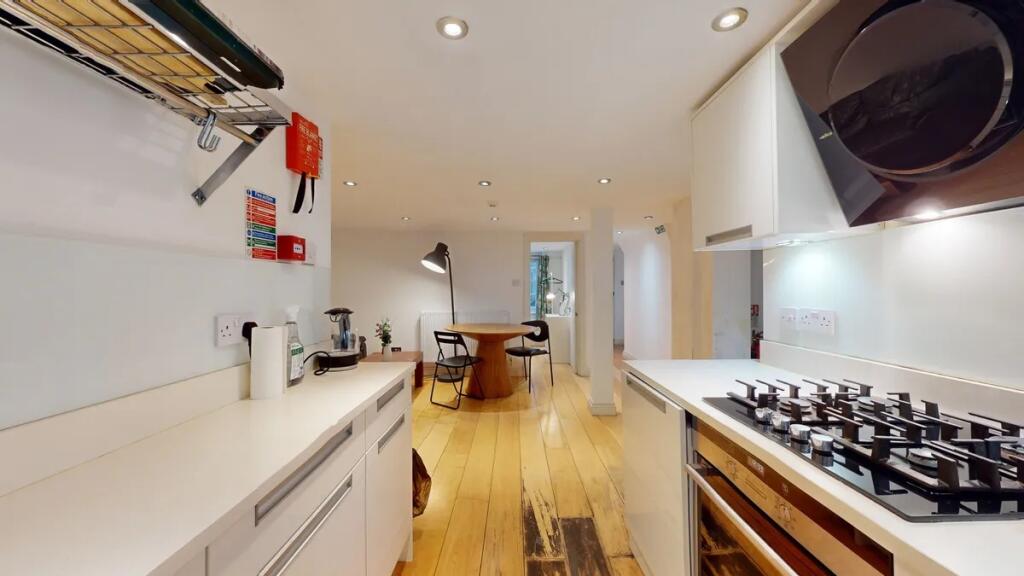 A modern and clean kitchen area featuring sleek...