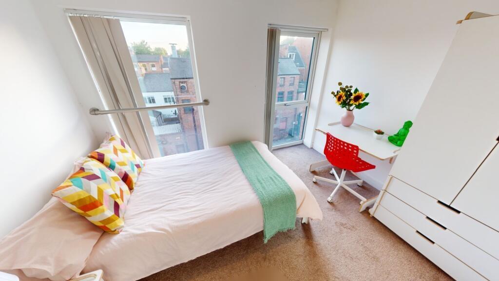 A bright and tidy single bedroom featuring a co...