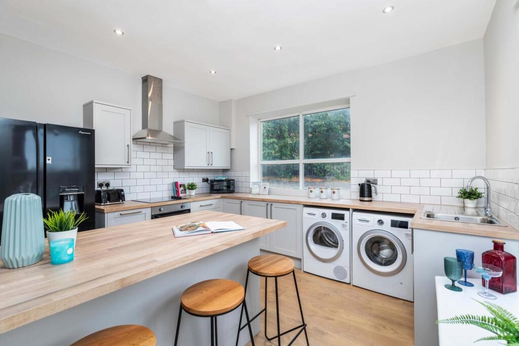 Bright modern kitchen with a breakfast bar, int...