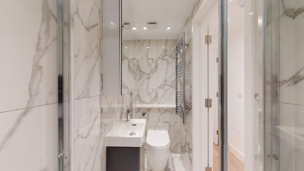 Bright and modern bathroom featuring elegant ma...