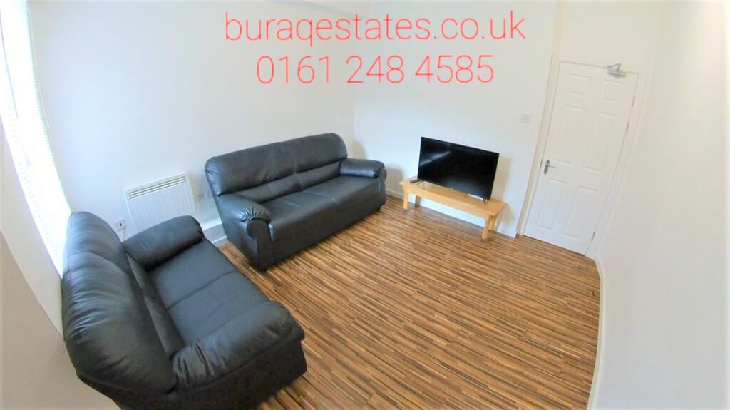 Bright, simply furnished living room with match...