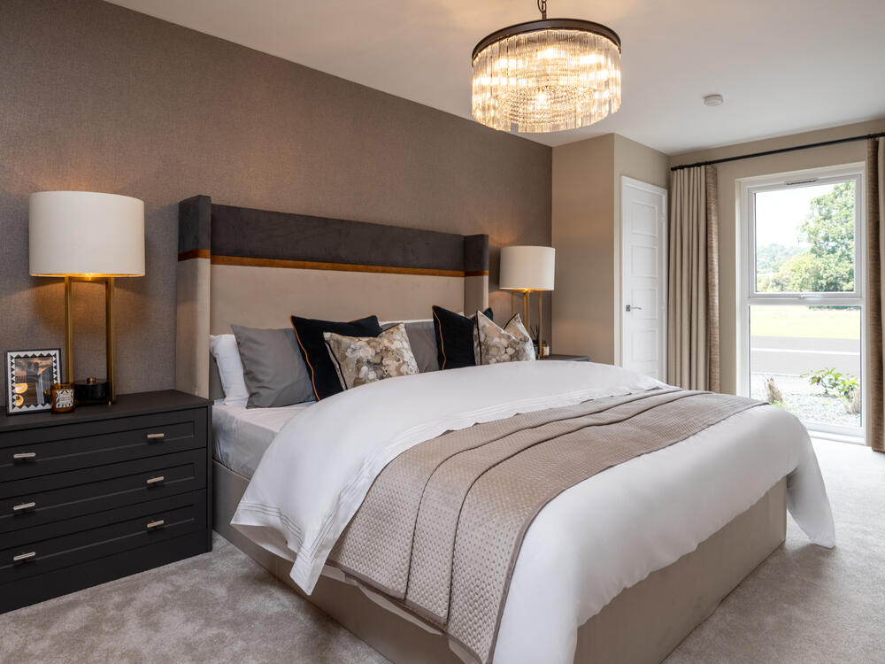 Image of bedroom with chest side table, and floor to ceiling window in a 2 bedroom apartment at Ston