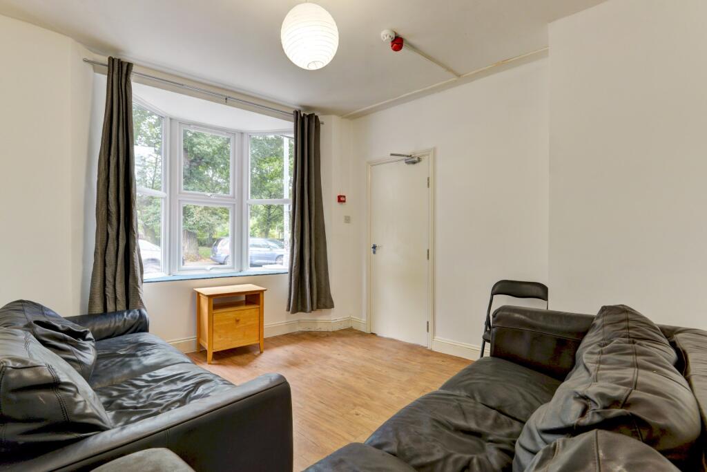 A comfortable living room featuring two dark so...