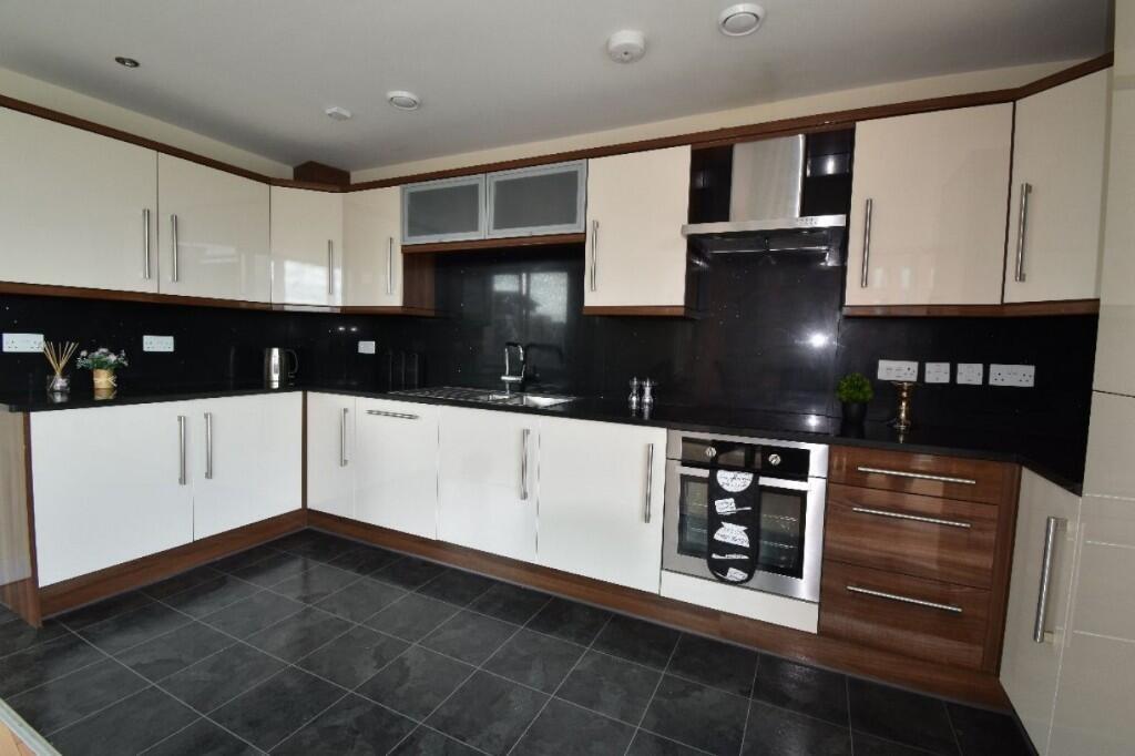 Modern kitchen featuring spacious countertops, ...