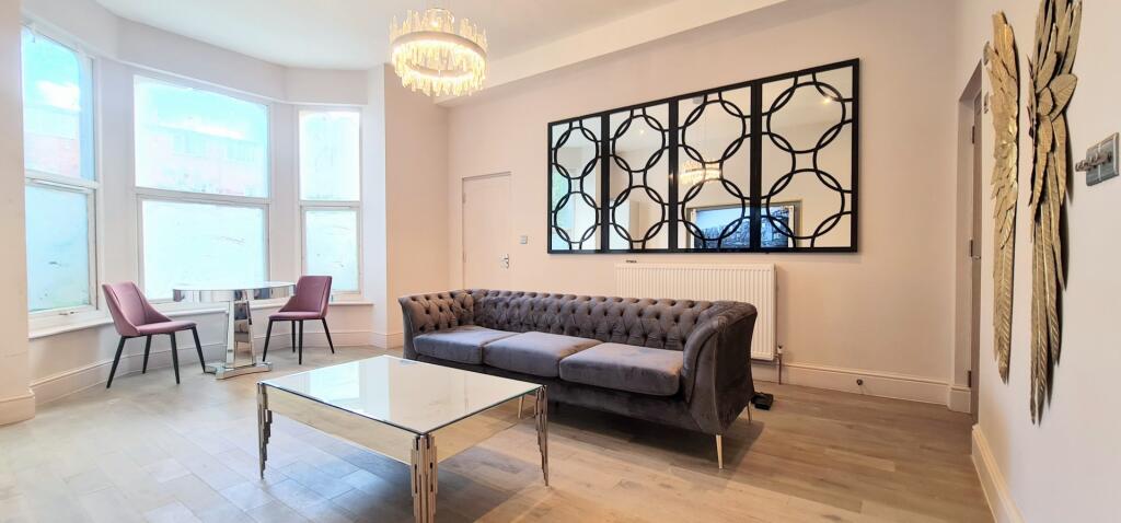 Bright and welcoming living space with large wi...