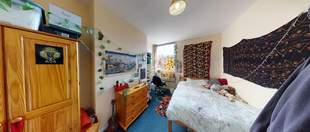 A cozy and well-decorated double bedroom filled...