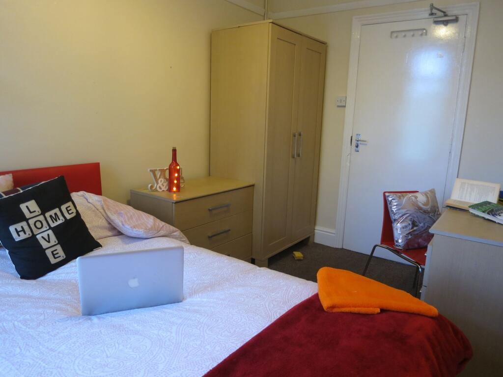 A comfortable bedroom featuring a double bed wi...