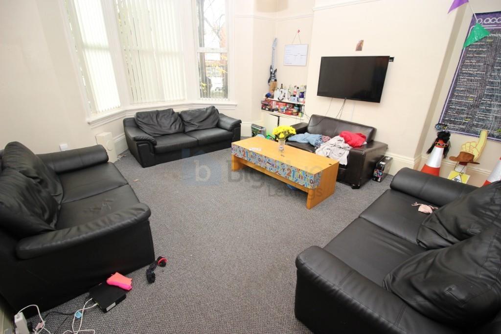 A comfortable living room with three black leat...