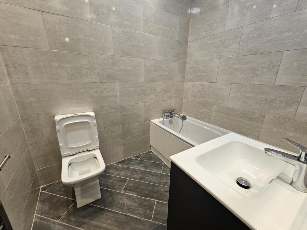 Modern bathroom suite featuring a clean and sle...