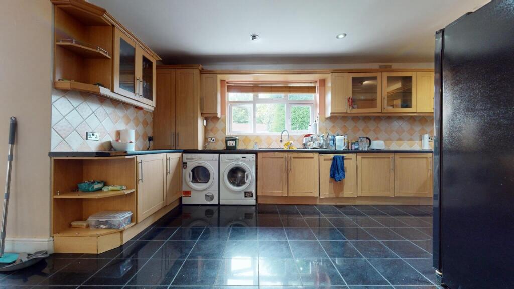 Bright and spacious kitchen featuring ample woo...