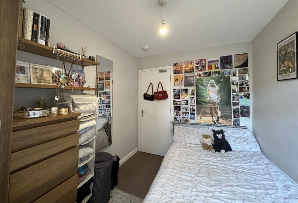 This inviting double bedroom features a cozy la...