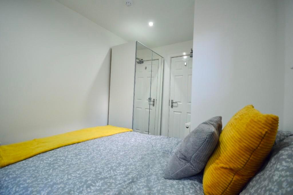 A stylish and cozy double bedroom featuring a c...