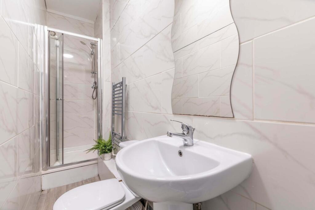 Bright, modern bathroom with a walk-in shower, ...