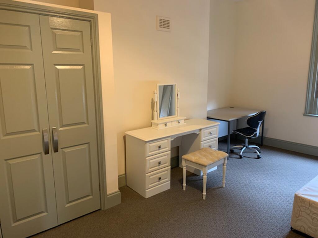 A bright and tidy double bedroom featuring a sp...