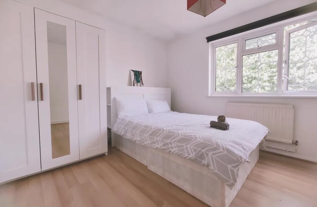 Bright and clean double bedroom featuring a com...
