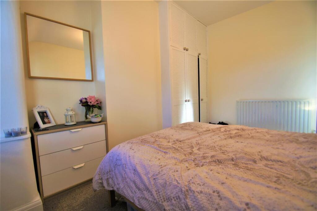 A charming double bedroom featuring soft lighti...