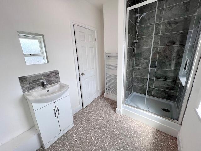 Bright and modern bathroom suite featuring a sp...