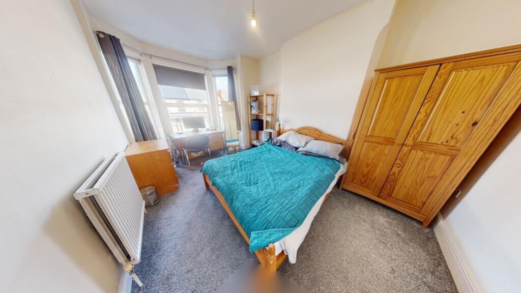 A bright and inviting double bedroom featuring ...