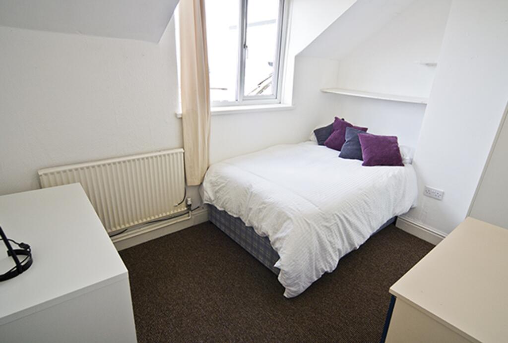 A bright and cozy double bedroom with a comfort...