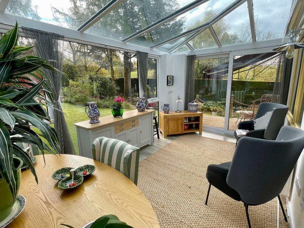Pretty sunroom with doors to the deck