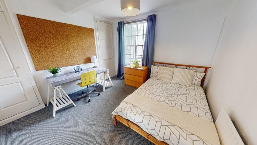A bright and spacious double bedroom featuring ...