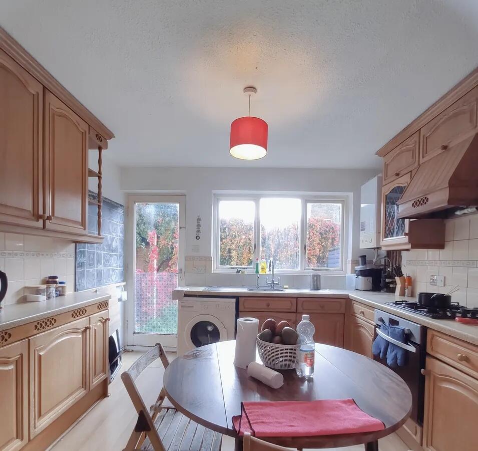 Bright and inviting kitchen with wooden cabinet...