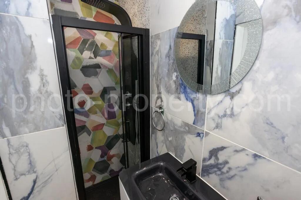 A beautifully designed bathroom featuring styli...
