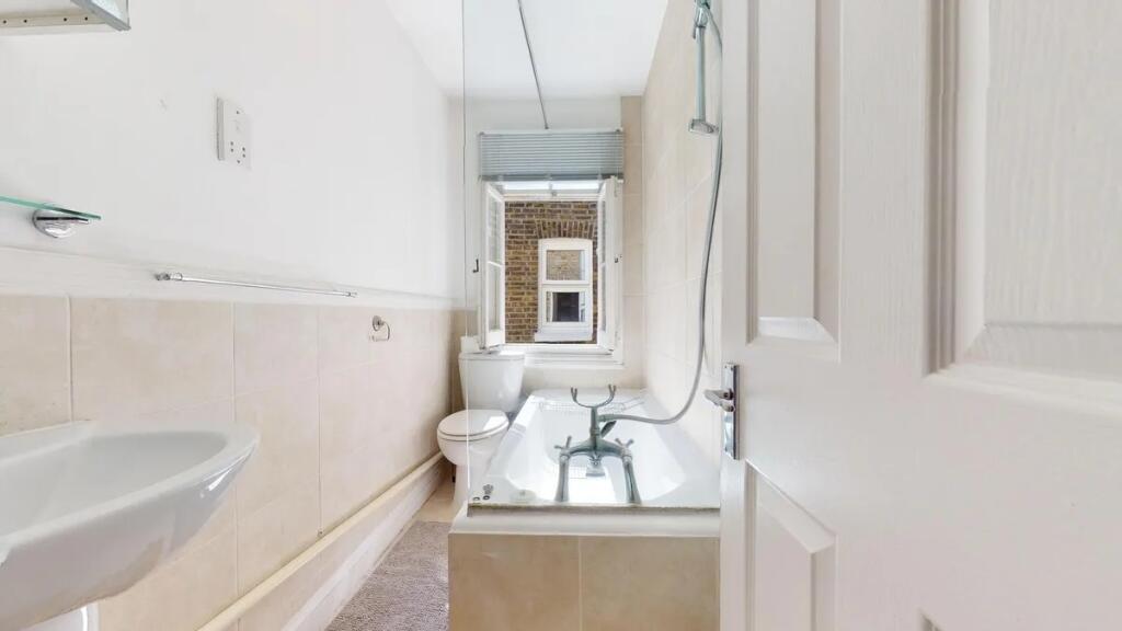 A bright and clean bathroom featuring a classic...
