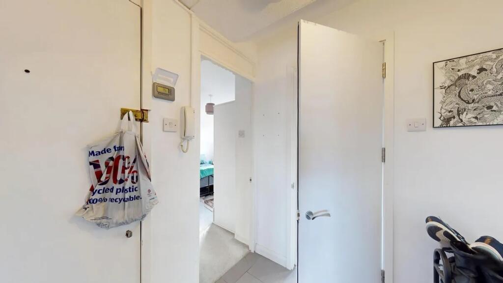 A neat and bright hallway with white walls and ...