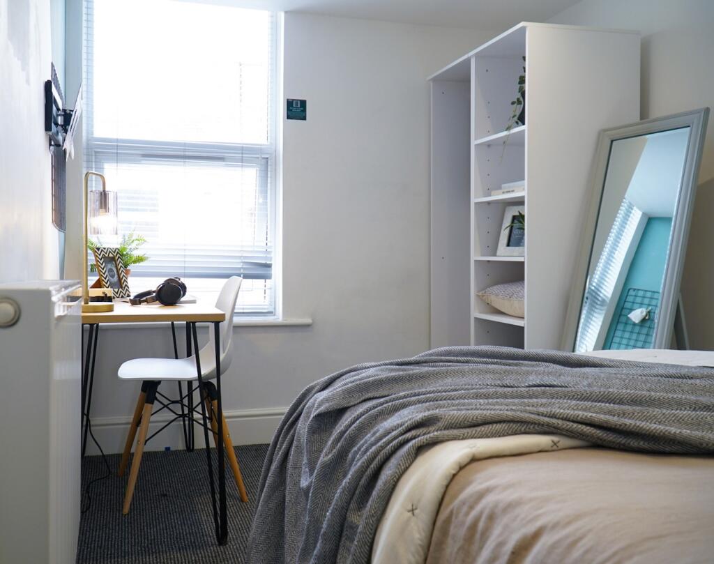 A bright and inviting double bedroom featuring ...