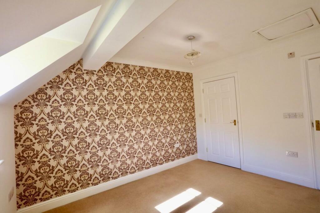Bedroom with feature wall paper, ensuite and walk 