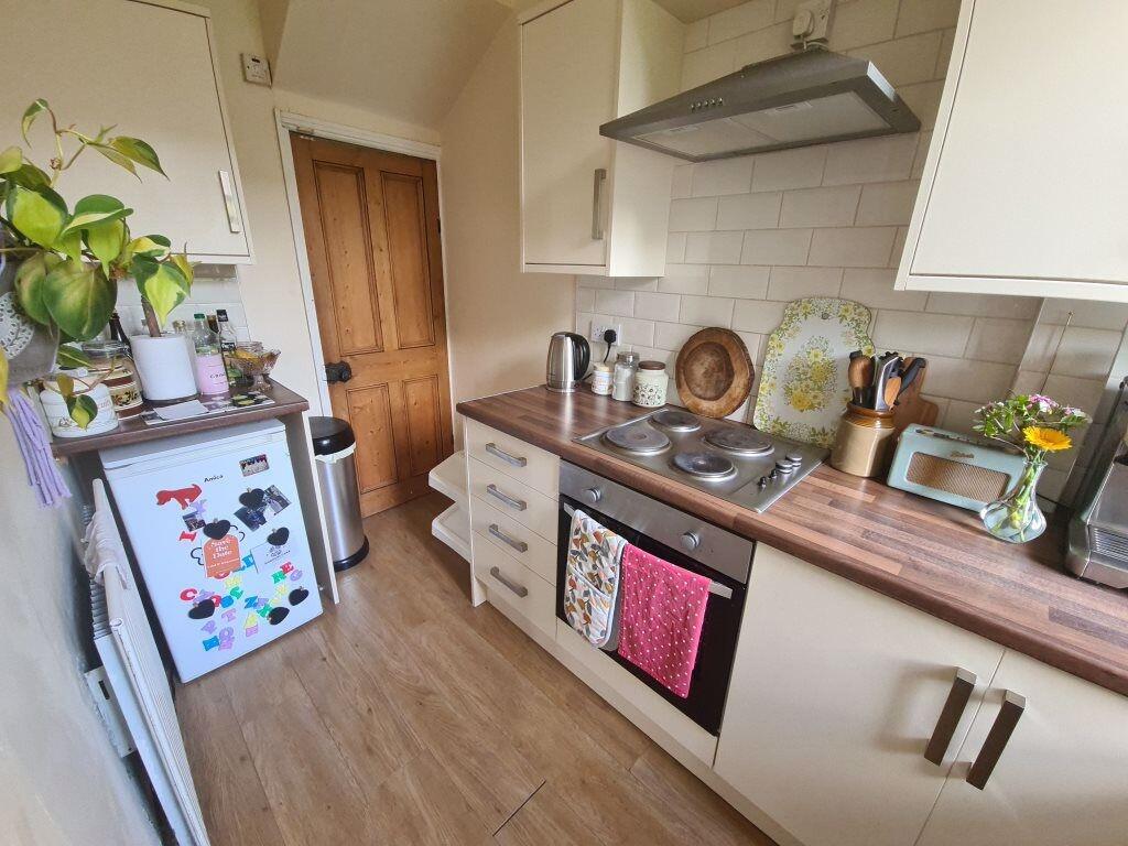 A bright and tidy kitchen featuring a modern la...
