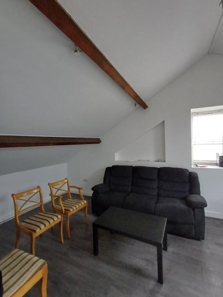 A cozy communal lounge featuring comfortable se...