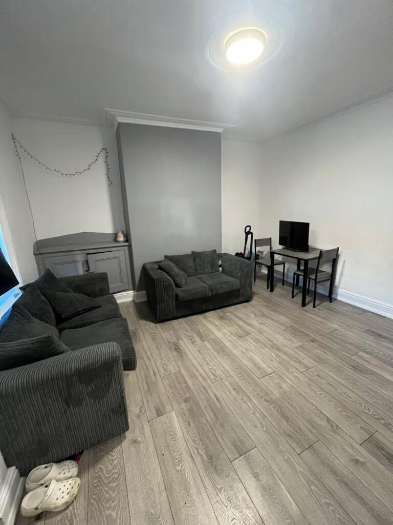 Spacious and well-maintained living room featur...