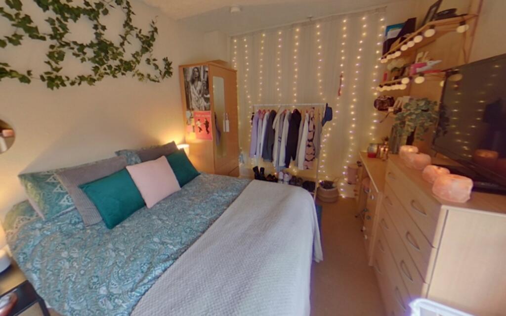 A cozy and well-decorated double bedroom featur...