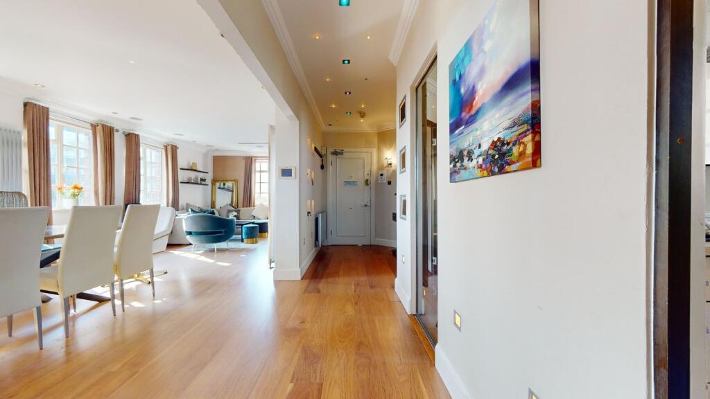 A bright and spacious living room featuring ele...