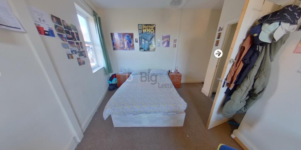Bright single bedroom featuring a neatly made b...