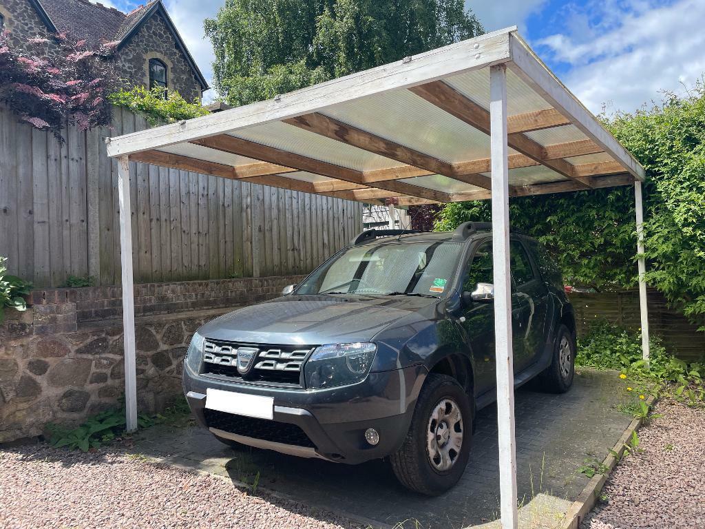 Car port located at the end of the drive