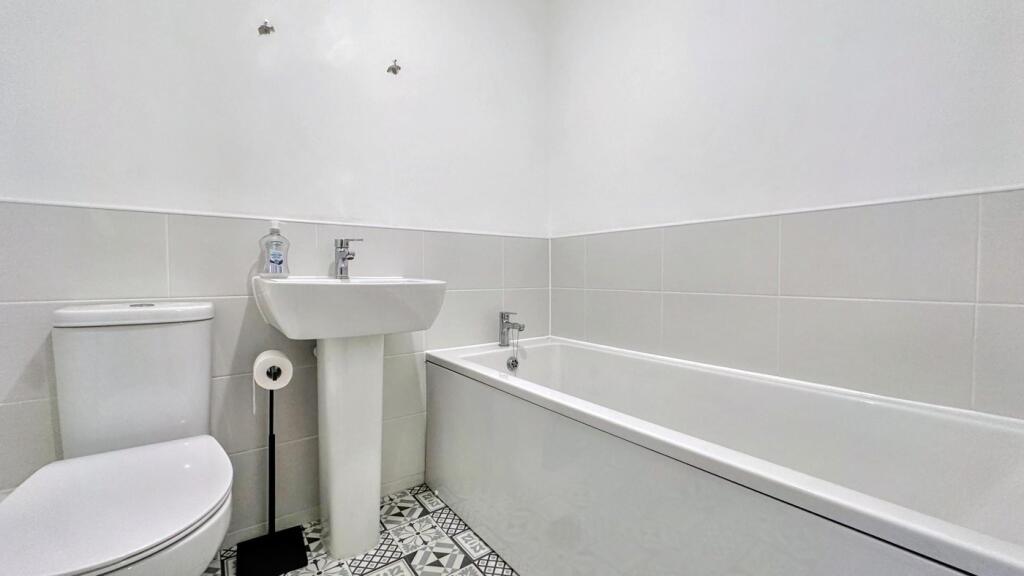 A bright and modern bathroom featuring a stylis...