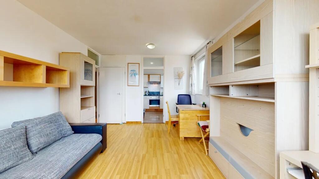 Bright and tidy living room with light wooden f...
